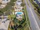 Aerial view of a home featuring a private pool, a well-manicured lawn, and lush tropical landscaping at 10812 Woodchase Cir, Orlando, FL 32836