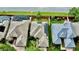 Aerial view of a home with a solar panel roof, surrounded by lush landscaping and a screened in pool at 10812 Woodchase Cir, Orlando, FL 32836