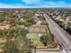 Aerial view of community amenities including tennis and basketball courts in a well-landscaped environment at 10812 Woodchase Cir, Orlando, FL 32836