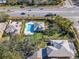 Aerial view of the property with private pool and manicured landscaping at 10812 Woodchase Cir, Orlando, FL 32836