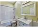 Well-lit bathroom featuring a shower and bath combination, white vanity, and modern fixtures at 10812 Woodchase Cir, Orlando, FL 32836