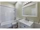 Bathroom featuring a shower-tub combo, framed mirror, and vanity with countertop at 10812 Woodchase Cir, Orlando, FL 32836