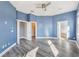 Spacious bedroom with blue walls, hardwood floors and access to bathroom at 10812 Woodchase Cir, Orlando, FL 32836