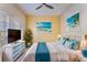 Inviting bedroom featuring coastal decor, soft bedding, and a bright, airy ambiance at 10812 Woodchase Cir, Orlando, FL 32836