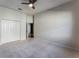 Spacious bedroom with neutral carpet, ceiling fan and double-door closet at 10812 Woodchase Cir, Orlando, FL 32836