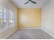 Well-lit bedroom with large window and yellow accent wall at 10812 Woodchase Cir, Orlando, FL 32836