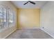 Neutral bedroom features large window and ceiling fan at 10812 Woodchase Cir, Orlando, FL 32836