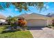 Single-story home with attached garage and well-manicured landscaping at 10812 Woodchase Cir, Orlando, FL 32836