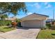 Two-car garage with a brick driveway and manicured landscaping, offering both convenience and curb appeal at 10812 Woodchase Cir, Orlando, FL 32836