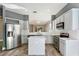 Modern kitchen with stainless steel appliances, gray cabinets, an island, and white countertops at 10812 Woodchase Cir, Orlando, FL 32836