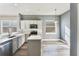 Bright kitchen featuring modern appliances, white cabinets, and a center island with ample counter space at 10812 Woodchase Cir, Orlando, FL 32836