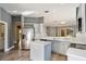 Open kitchen with stainless steel appliances, white cabinets, and an island, perfect for entertaining at 10812 Woodchase Cir, Orlando, FL 32836