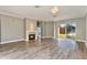 Open-concept living room with a fireplace, hardwood floors, and sliding glass doors to the backyard at 10812 Woodchase Cir, Orlando, FL 32836
