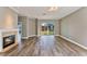 Cozy living room with hardwood floors, a fireplace, and sliding glass doors offering natural light at 10812 Woodchase Cir, Orlando, FL 32836