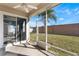 Screened-in porch overlooking backyard with grassy area at 10812 Woodchase Cir, Orlando, FL 32836