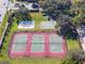 Aerial view of the community tennis courts also shows basketball and sand volleyball courts at 10812 Woodchase Cir, Orlando, FL 32836