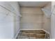 Walk-in closet with custom shelving and plenty of storage space for organization at 10812 Woodchase Cir, Orlando, FL 32836