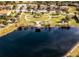 Aerial view of community with lake, park, and homes at 10875 Savona Way, Orlando, FL 32827