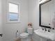 Small bathroom with toilet and pedestal sink at 10875 Savona Way, Orlando, FL 32827