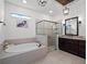 Elegant bathroom with soaking tub and walk-in shower at 10875 Savona Way, Orlando, FL 32827