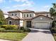 Two-story home with tile roof and stone accents at 10875 Savona Way, Orlando, FL 32827