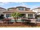 Back exterior view of home showcasing pool and patio area at 10875 Savona Way, Orlando, FL 32827