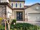 Elegant two-story home entryway with double doors at 10875 Savona Way, Orlando, FL 32827