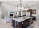 Modern kitchen island with granite countertop and wine rack at 10875 Savona Way, Orlando, FL 32827