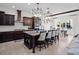 Bright kitchen with an island, dark cabinetry, and granite countertops at 10875 Savona Way, Orlando, FL 32827