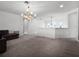 Open living area with a contemporary chandelier at 10875 Savona Way, Orlando, FL 32827