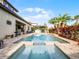 Outdoor kitchen and dining area near the pool at 10875 Savona Way, Orlando, FL 32827