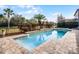 Inviting, rectangular pool with a spa and a large patio at 10875 Savona Way, Orlando, FL 32827