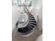 Elegant curved staircase with chandelier at 10875 Savona Way, Orlando, FL 32827