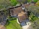 Aerial view of the charming home, mature trees, and lush green lawn at 123 Golf Club Dr, Longwood, FL 32779