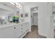 Bright bathroom featuring double sinks, decorative accents, and a closet at 123 Golf Club Dr, Longwood, FL 32779