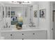 Bright bathroom featuring double sinks, decorative accents, and a view of the bedroom at 123 Golf Club Dr, Longwood, FL 32779