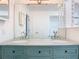 Teal vanity with granite countertop, double sinks, and updated lighting at 123 Golf Club Dr, Longwood, FL 32779