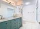 Updated bathroom with teal vanity, granite countertop, and double sinks at 123 Golf Club Dr, Longwood, FL 32779