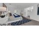 Bright bedroom with a ceiling fan, geometric patterned rug, and a view into an ensuite bathroom at 123 Golf Club Dr, Longwood, FL 32779