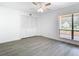 Spacious bedroom with grey wood-look floors and large window at 123 Golf Club Dr, Longwood, FL 32779