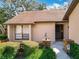 Front view of condo showing entryway, landscaping, and brick facade at 123 Golf Club Dr, Longwood, FL 32779