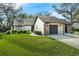 Charming single Gathering home featuring a well-manicured lawn and attached garage at 123 Golf Club Dr, Longwood, FL 32779