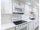 Modern white kitchen with new appliances and quartz countertops at 123 Golf Club Dr, Longwood, FL 32779