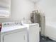 Bright laundry room with washer, dryer, and water heater at 123 Golf Club Dr, Longwood, FL 32779