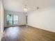 Light and airy living room features grey wood-look floors and a ceiling fan at 123 Golf Club Dr, Longwood, FL 32779