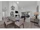 Living and dining room featuring modern lighting and a brick fireplace at 123 Golf Club Dr, Longwood, FL 32779