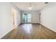 Bright living room with grey wood-look floors and sliding glass doors at 123 Golf Club Dr, Longwood, FL 32779