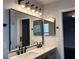 Bathroom featuring a dual sink vanity with modern countertops and stylish mirrors at 13124 Oulton Cir, Orlando, FL 32832