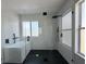 Modern shower area with herringbone tile detail, matte black hardware, and glass enclosure at 13124 Oulton Cir, Orlando, FL 32832