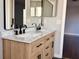 Bathroom featuring a dual sink vanity, modern countertops and stylish mirrors at 13124 Oulton Cir, Orlando, FL 32832